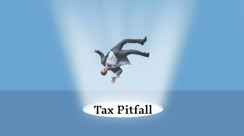 Man falling through "tax pitfall" hole